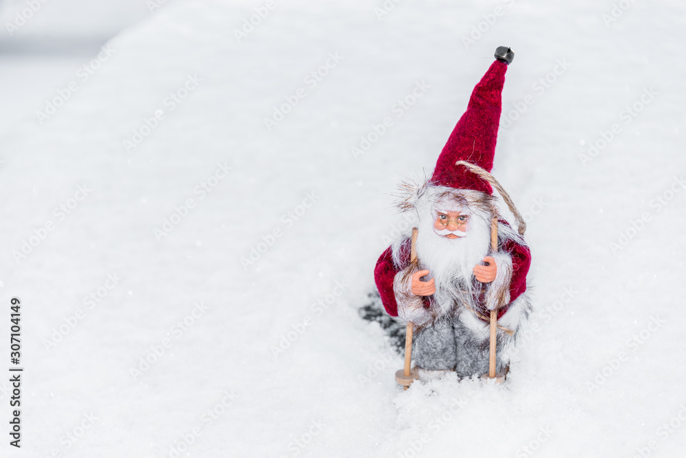 Santa Doll with Skis on Snow for Christmas