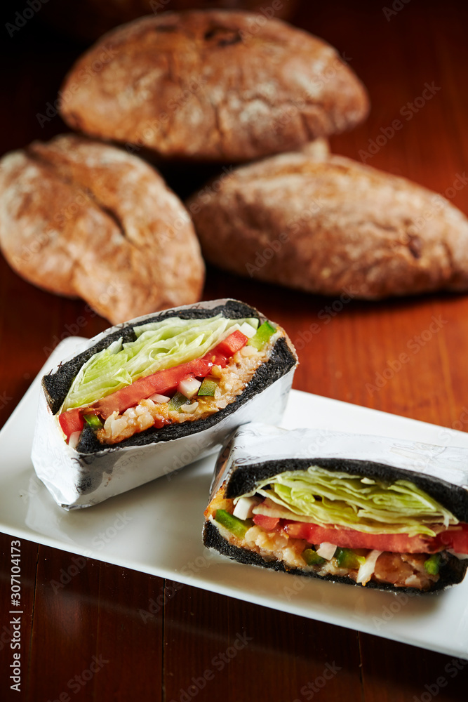Black bread sandwich with baguette on background Black bread sandwich with baguette on background