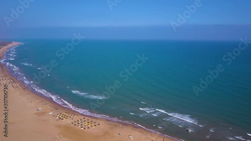 Beautiful View over Moroccan beach with waves and sand. Filmed with a drone. photo