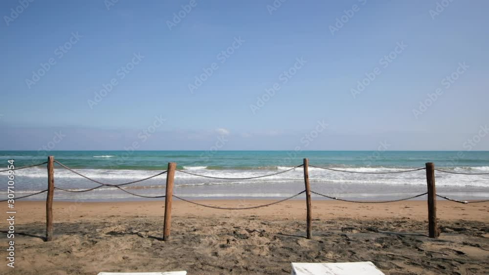 Arriving on a beautiful sandy beach in Morocco. Filmed in motion in the north of Africa by the Mediterranean Sea. On the beach chairs and fences. Arriving on a beautiful sandy beach in Morocco. Filmed in motion in the north of Africa by the Mediterranean Sea. On the beach chairs and fences.