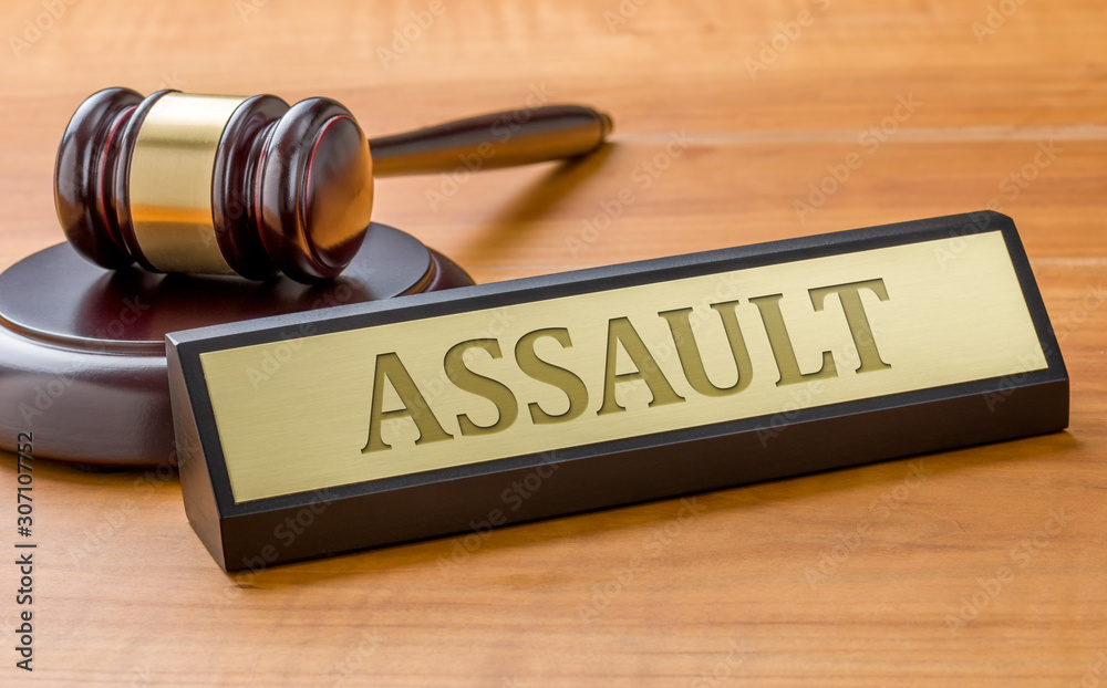 A gavel and a name plate with the engraving Assault A gavel and a name plate with the engraving Assault