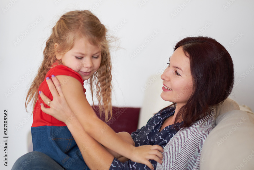 mom and daughter are hugging at home mom and daughter are hugging at home