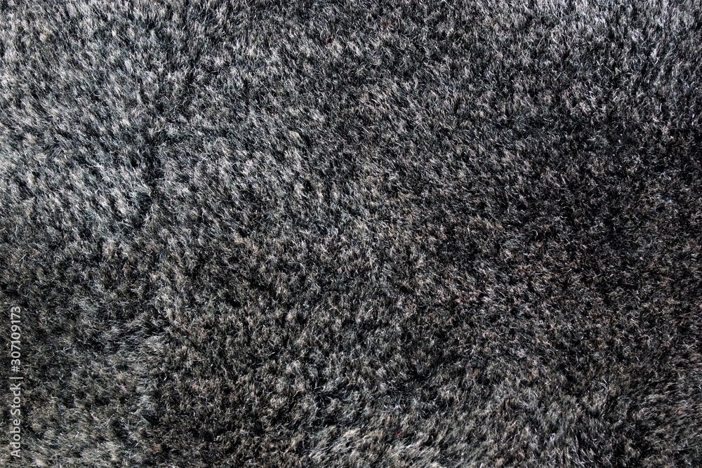Fototapeta premium Artificial fur color anthracite-sewing textile material, imitating natural fur, wildlife protection. Used in the manufacture of clothing, hats, soft toys. Low cost, light weight.