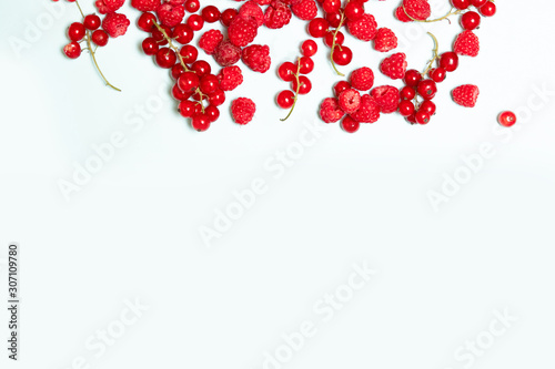 Fresh juicy raspberry berries on a blue background with copyspace. Top view ,flat lay