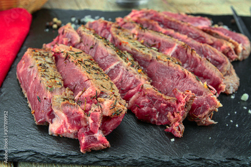 rib of beef grilled in slice on a wooden table
