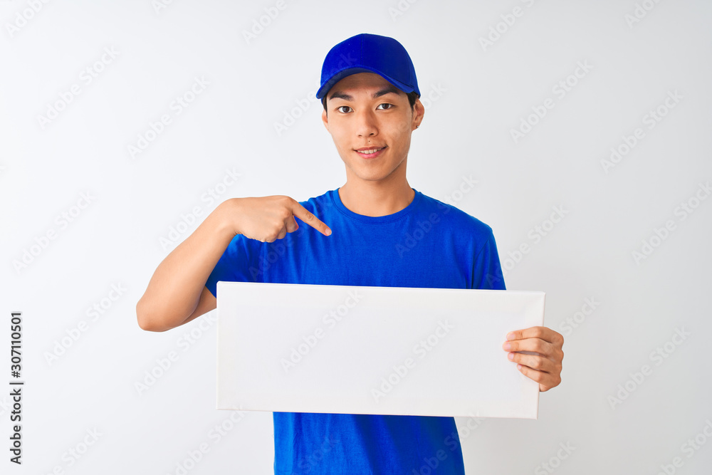 Chinese deliveryman wearing cap holding banner standing over isolated white background with surprise face pointing finger to himself Chinese deliveryman wearing cap holding banner standing over isolated white background with surprise face pointing finger to himself