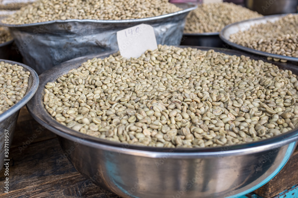 Green unroasted coffee beans for sale in a market