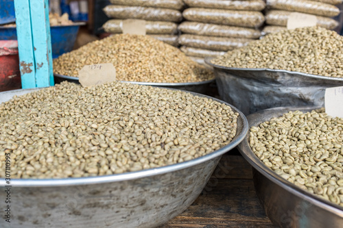 Green unroasted coffee beans for sale in a market photo