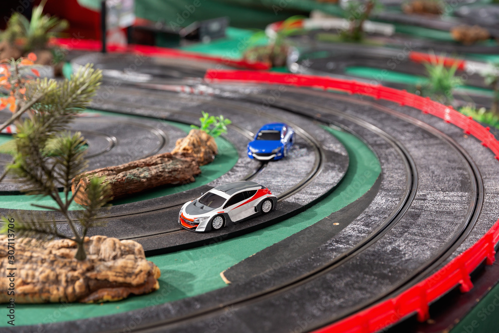 Electric slot cars on the toy race track reader to play
