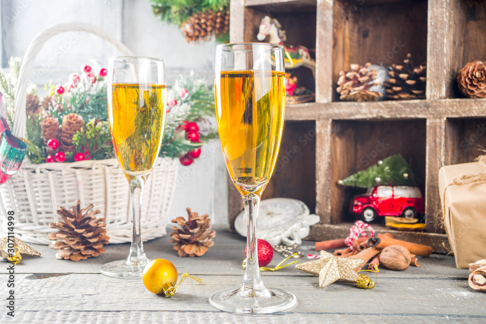 Two champagne glasses with christmas decoration on wooden snow background. Happy New Year and  christmas Celebration.