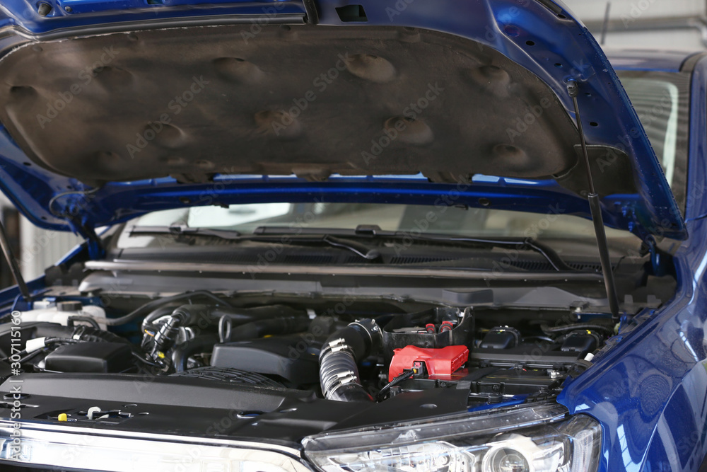 Car with open hood in service center, closeup Car with open hood in service center, closeup