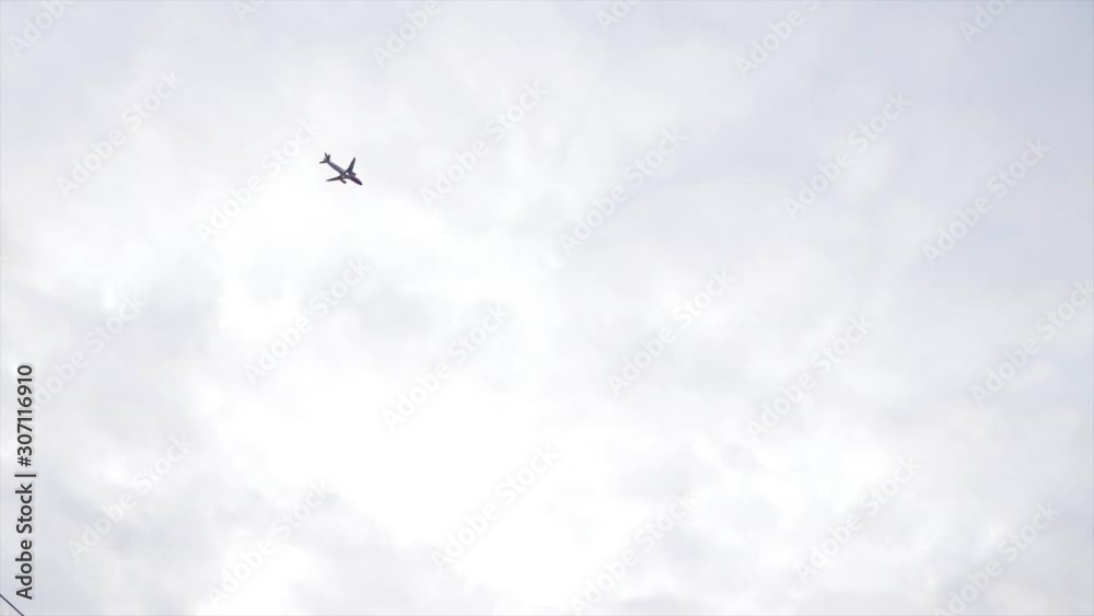Plane flying in the sky above an urban city. Traveling by air. Up in the air. Airplane on grey clouds. Plane flying in the sky above an urban city. Traveling by air. Up in the air. Airplane on grey clouds.