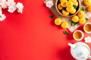 Chinese new year festival decorations pow or red packet, orange and gold ingots or golden lump on a red background. Chinese characters FU in the article refer to fortune good luck, wealth, money flow.