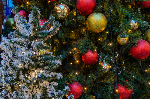 Fotografi Christmas tree decorated with red and gold balls, garland and artificial snow