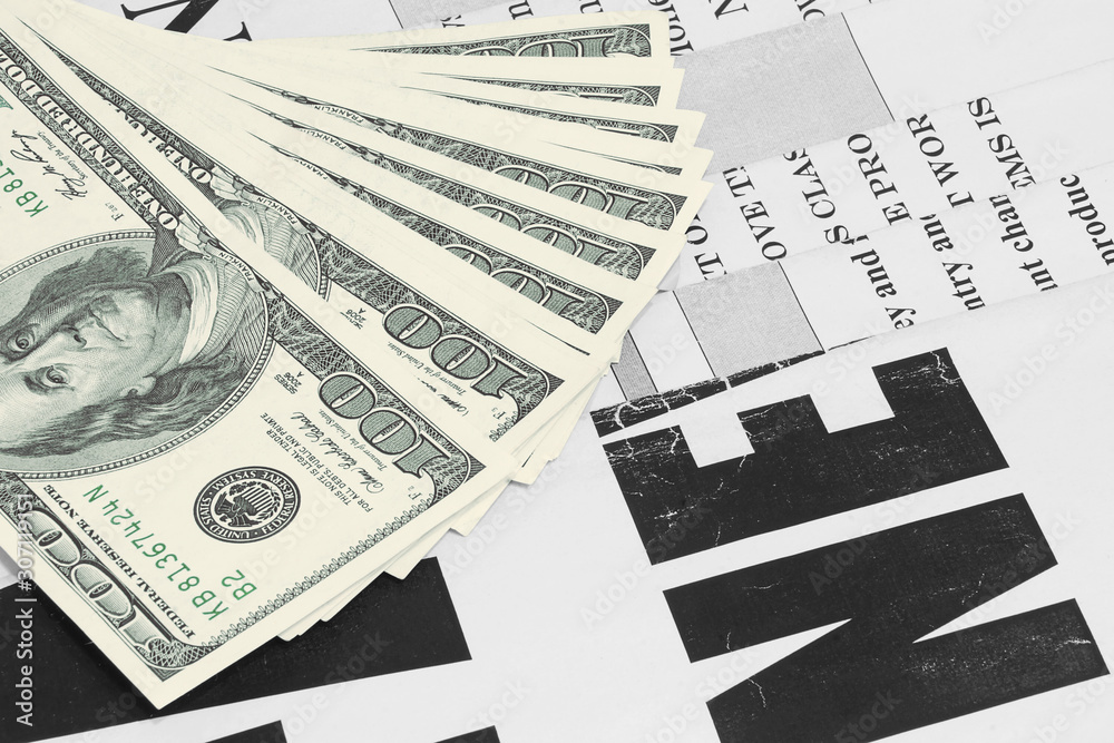 Obraz premium Old Newspapers and Money. News Pages with Headlines and One Hundred Dollar Bills. Magazines and US Currency in Cash. Business and Finance Background 