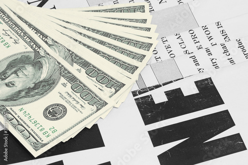 Old Newspapers and Money. News Pages with Headlines and One Hundred Dollar Bills. Magazines and US Currency in Cash. Business and Finance Background 