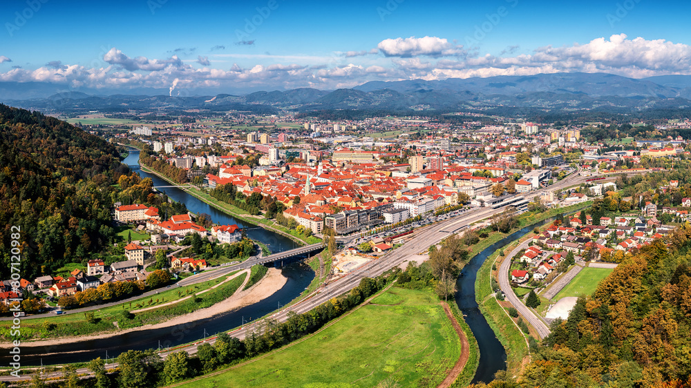 City of Celje in Slovenia, Styria, panoramic aerial view from old castle ancient walls. Amazing landscape with town in Lasko valley, river Savinja and blue sky with clouds, outdoor travel background