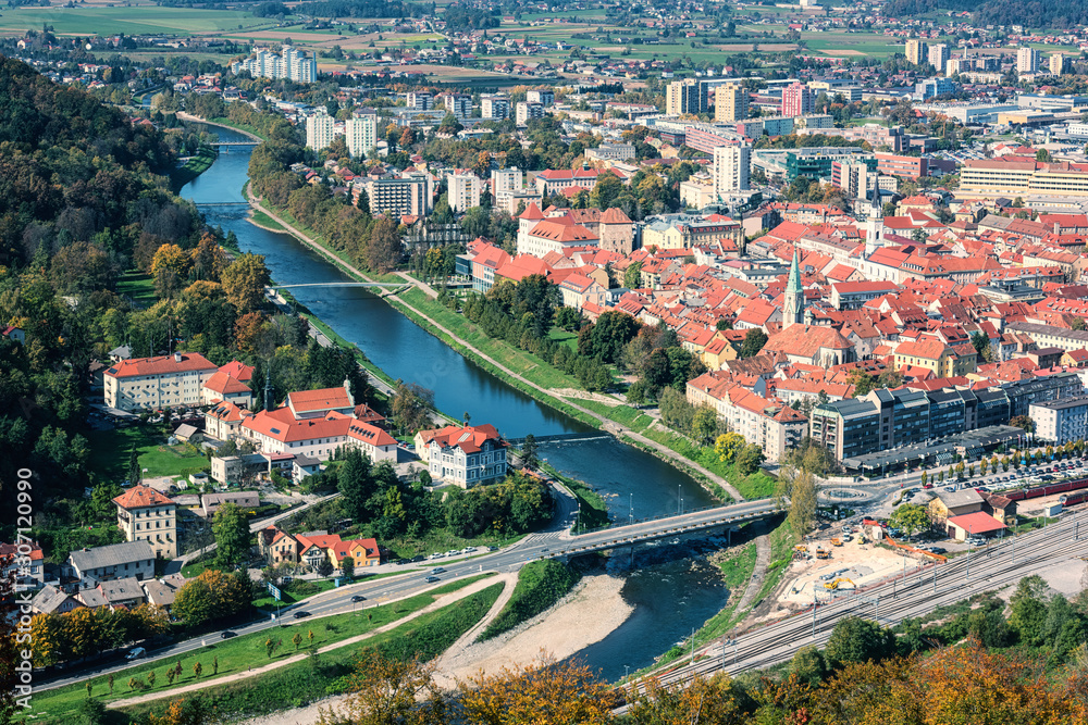City of Celje in Slovenia, Styria, panoramic aerial view from old castle ancient walls. Amazing landscape with town in Lasko valley, river Savinja and blue sky with clouds, outdoor travel background