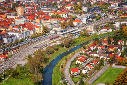 City of Celje in Slovenia, Styria, panoramic aerial view from old castle ancient walls. Amazing landscape with town in Lasko valley, river Savinja and blue sky with clouds, outdoor travel background