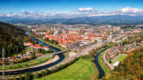 City of Celje in Slovenia  Styria  panoramic aerial view from old castle ancient walls. Amazing landscape with town in Lasko valley  river Savinja and blue sky with clouds  outdoor travel background