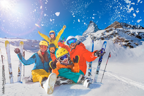 Obraz na płótnie Happy family enjoying winter vacations in mountains. Playing with snow, Sun in high mountains. Winter holidays. w salonie