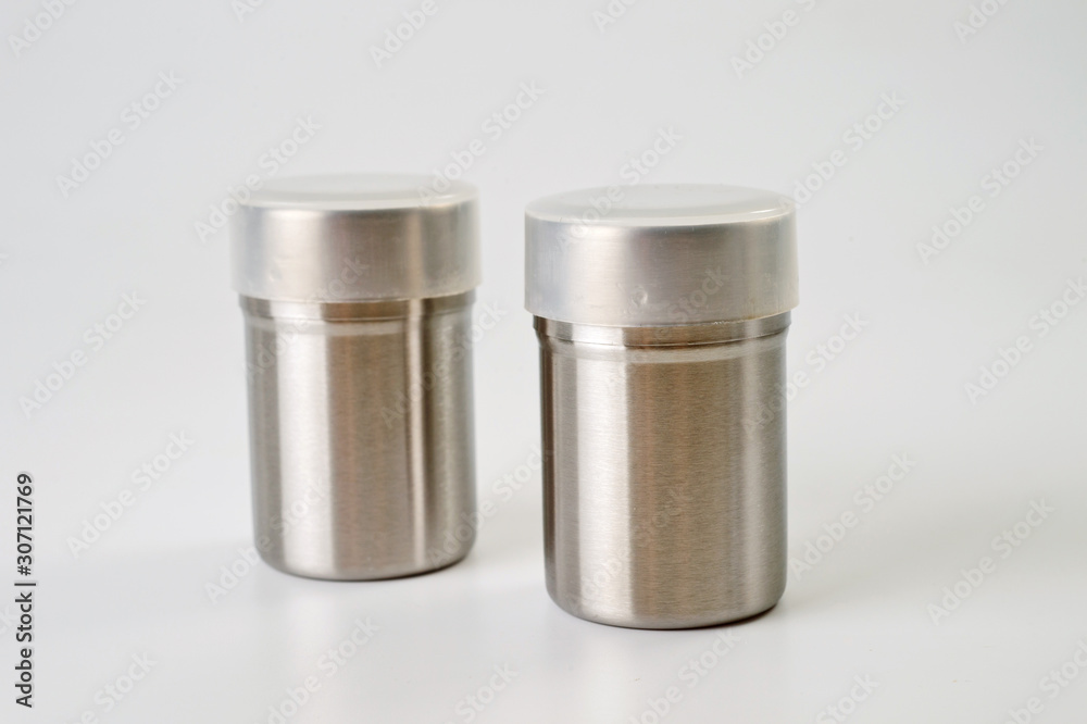 Metal containers with holes in the lids for salt and pepper, for serving the kitchen table Metal containers with holes in the lids for salt and pepper, for serving the kitchen table