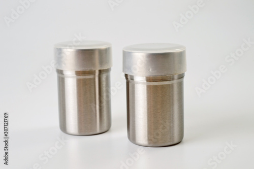 Metal containers with holes in the lids for salt and pepper, for serving the kitchen table