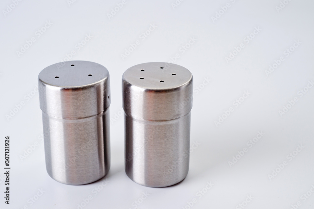 Metal containers with holes in the lids for salt and pepper, for serving the kitchen table Metal containers with holes in the lids for salt and pepper, for serving the kitchen table