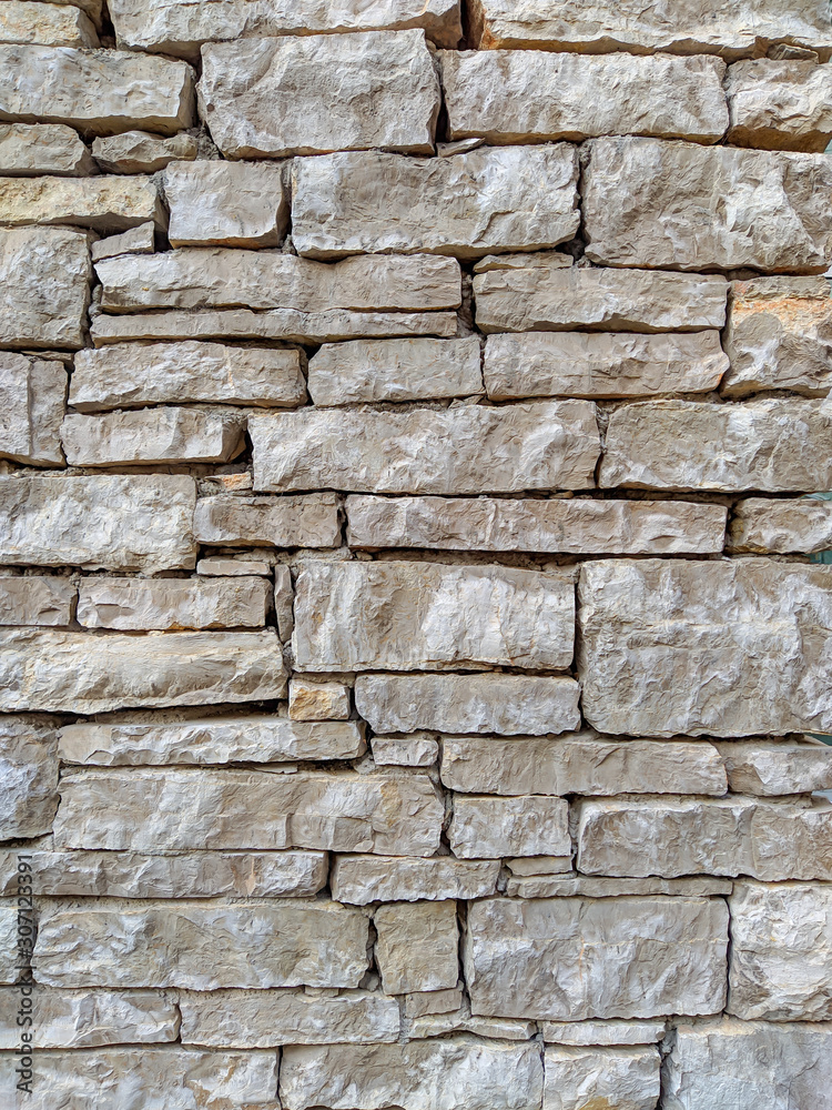 Modern uneven bricks made of stone and rock making an interesting wall for indoors and outdoors Modern uneven bricks made of stone and rock making an interesting wall for indoors and outdoors
