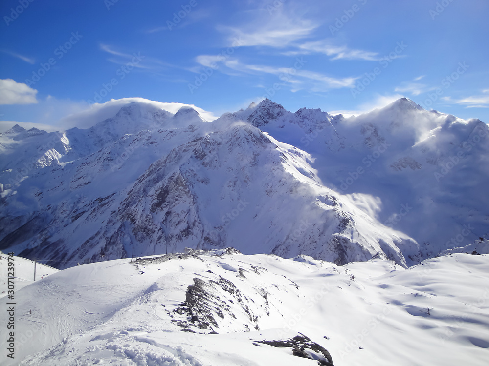 Panorama of winter mountains in a sunny day.