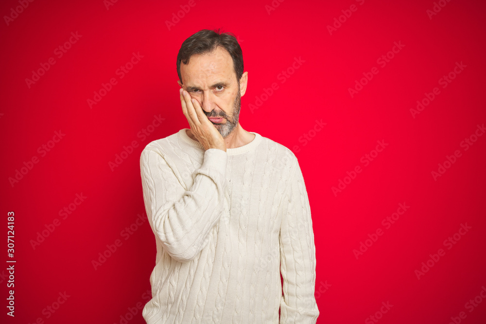 Handsome middle age senior man with grey hair over isolated red background thinking looking tired and bored with depression problems with crossed arms. Handsome middle age senior man with grey hair over isolated red background thinking looking tired and bored with depression problems with crossed arms.