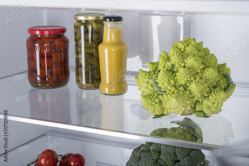 Open fridge full of fresh fruits and vegetables