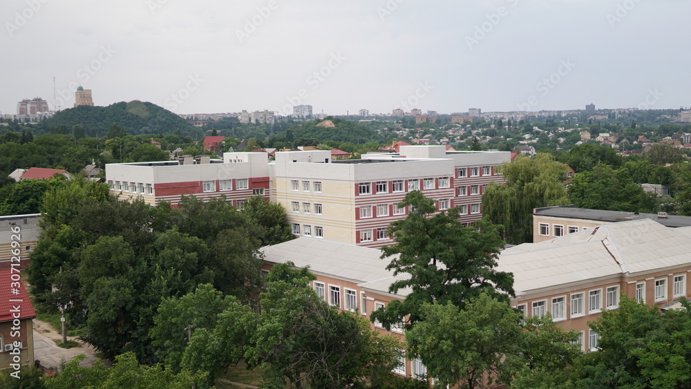 Cityscape. View of the school from the roof of a tall house