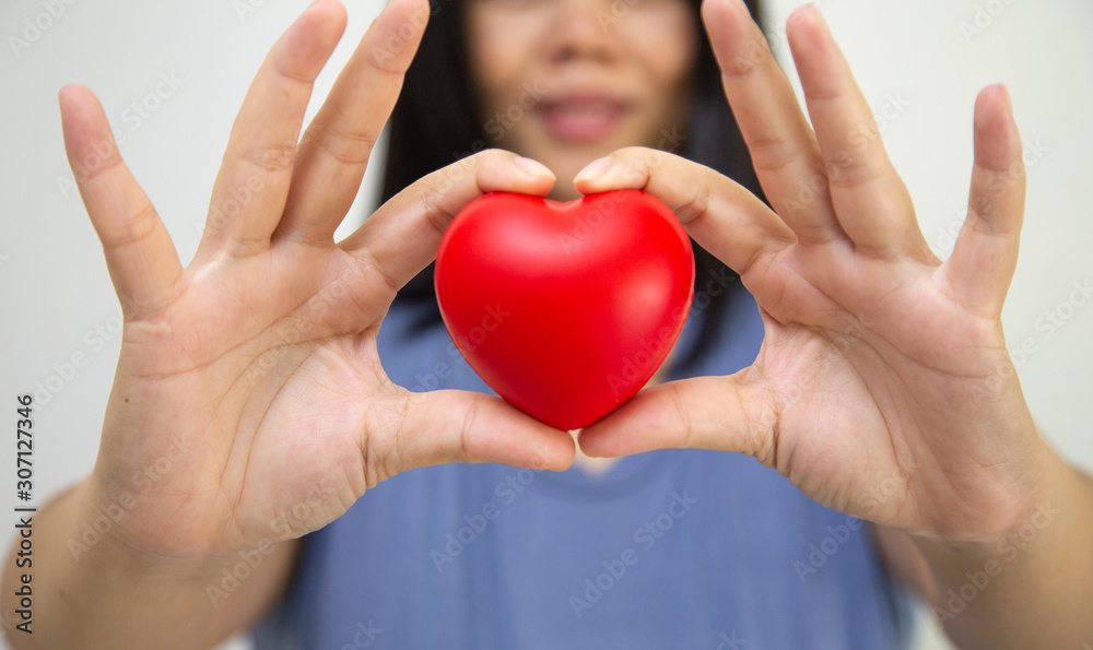 Pregnant women holding red hearts, Concept: Family expectations Happy lifestyle,mother in dress holds hands on belly,