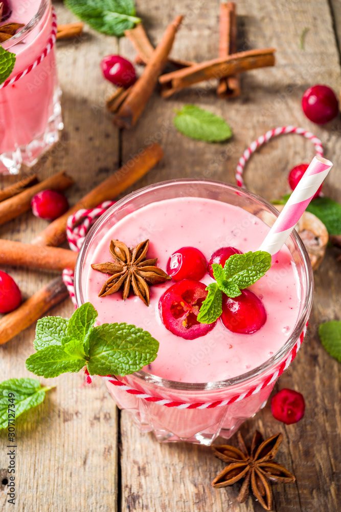Autumn winter vitamin healthy drink. Homemade cranberry smoothie with mint and spices, wooden background