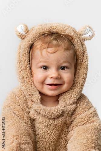 Cute smiling baby in hooded bear suit photo