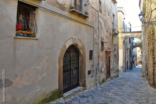 Fototapeta Naklejka Na Ścianę i Meble -  Sessa Aurunca, Italy, 11/30/2019. A small street among the old houses of a medieval village in the province of Caserta
