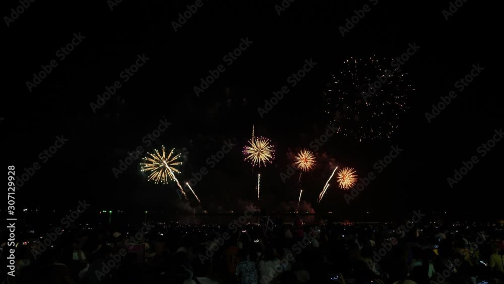 Real fireworks background and people who come to watch on the beach Pattaya International Fireworks Festival. New year's eve fireworks celebration Asia Thailand Real fireworks background and people who come to watch on the beach Pattaya International Fireworks Festival. New year's eve fireworks celebration Asia Thailand