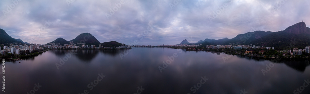 Full 360 degrees aerial panorama of the city lake in Rio de Janeiro on an overcast early morning with the Corcovado mountain and hints of blue and purple in the sky