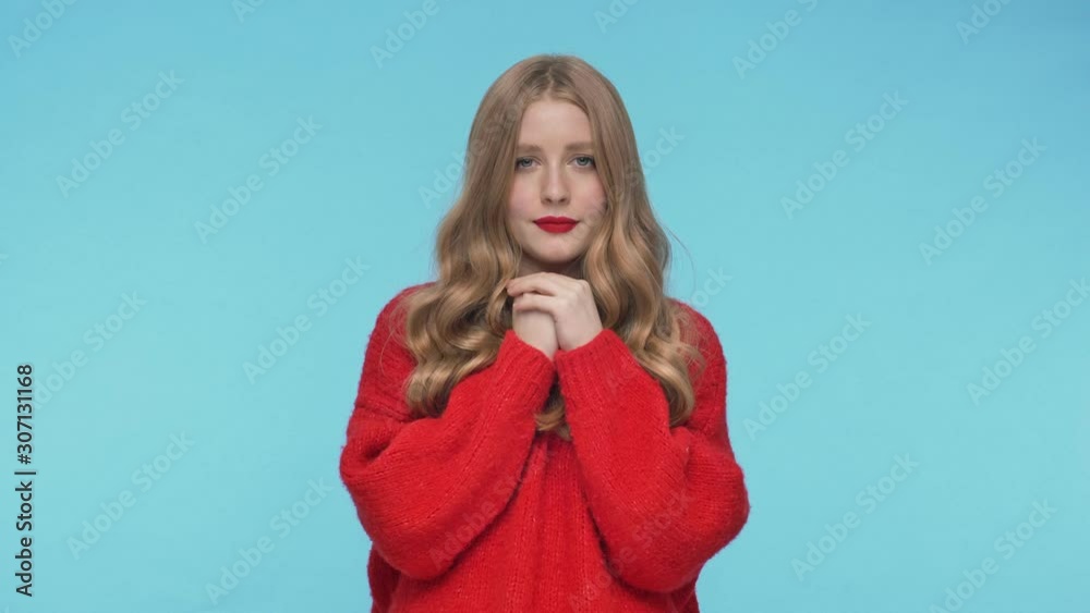 Young pretty woman in sweater having runny nose and sneezing over turquoise background Young pretty woman in sweater having runny nose and sneezing over turquoise background