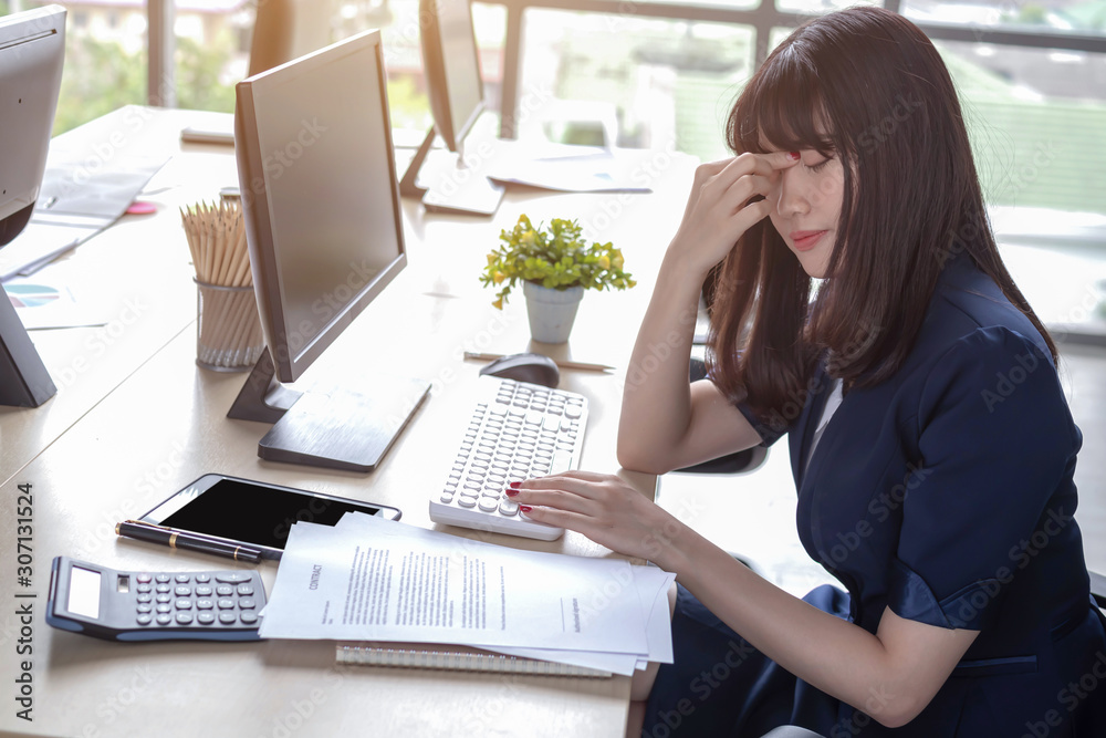 Beautiful, stressful employee at the office desk Beautiful, stressful employee at the office desk