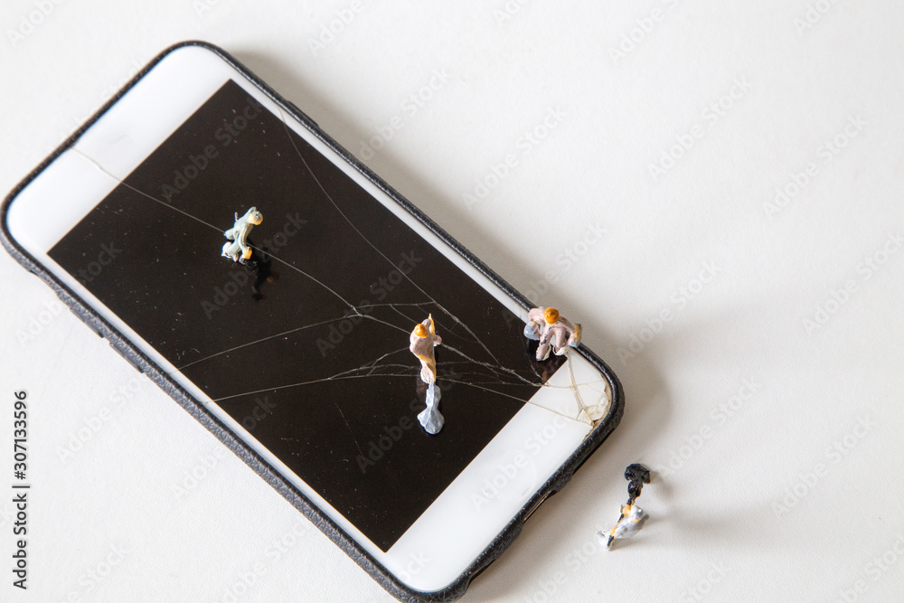 miniature people repair smartphone top view, The model of teamwork technology tools to fix a cracked screen, Plan of ideas and help with broken digital communication materials