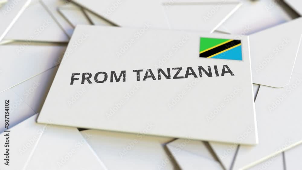 Envelope with From Tanzania text on pile of other envelopes. International mail related conceptual 3D animation