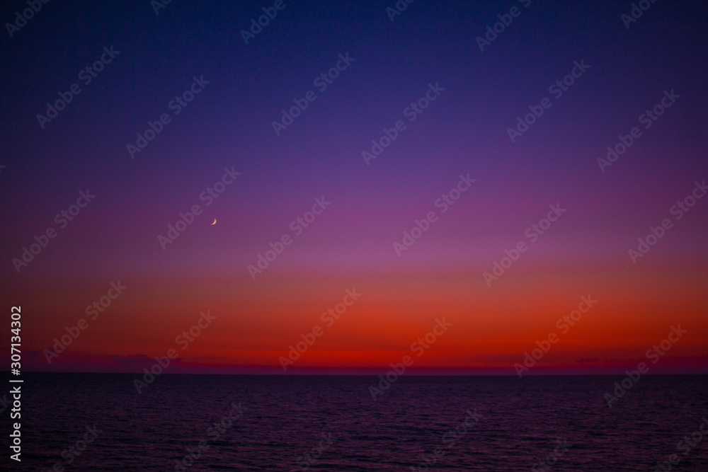 beautiful sunset on the beach. the multi-colored sky in all gradients. blue purple pink red sky over the black sea beautiful sunset on the beach. the multi-colored sky in all gradients. blue purple pink red sky over the black sea