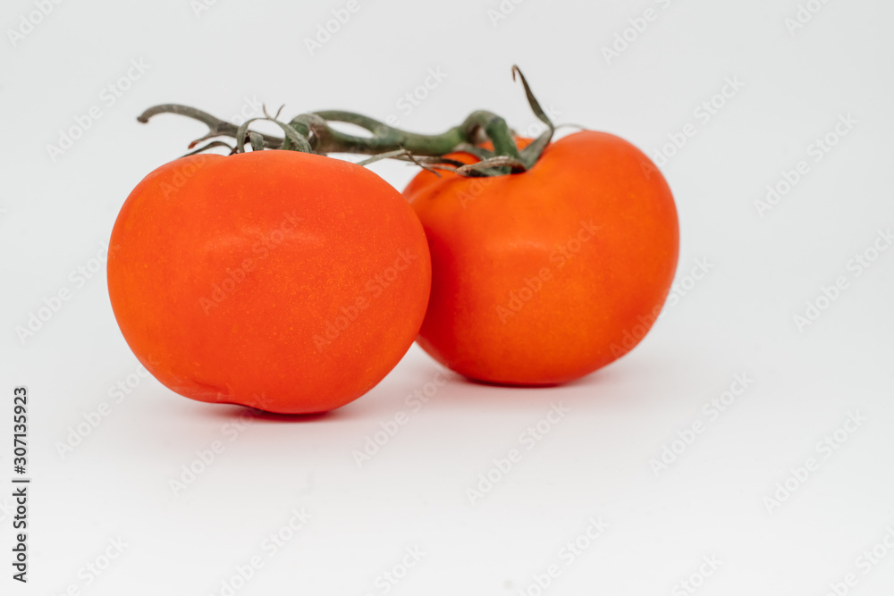 Red tomato on a white background close-up Red tomato on a white background close-up