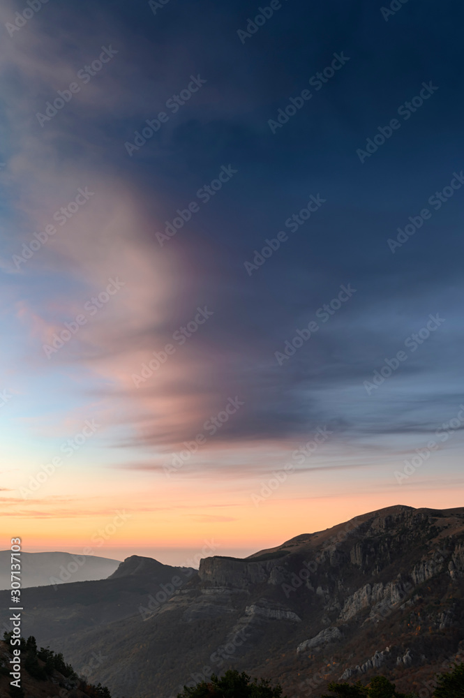 Vertical background with beautiful sunset in the mountains. Scenic view