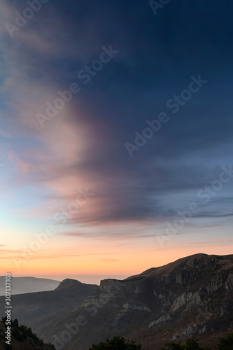 Vertical background with beautiful sunset in the mountains. Scenic view © kovaleva_ka
