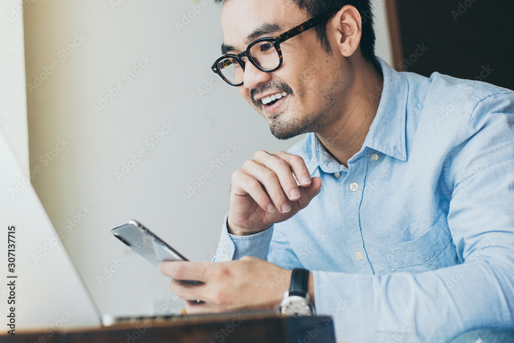 hand holding using texting cell phone and typing computer.businessman at workplace Thinking investment plan.chatting contact Investor.searching for information use internet.connecting people concept hand holding using texting cell phone and typing computer.businessman at workplace Thinking investment plan.chatting contact Investor.searching for information use internet.connecting people concept