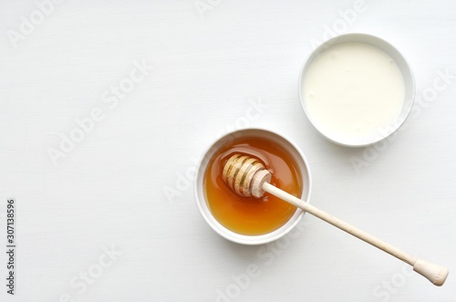 Honey and yogurt, ingredients for homemade natural face mask, skin treatment, top view, copy space.