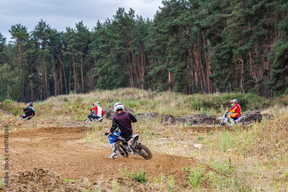 Motocross rider on a practice field . Front View Shot of the Professional Motocross . Dirt Track. Motocross rider on a practice field . Front View Shot of the Professional Motocross . Dirt Track.